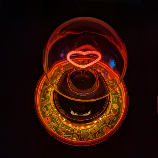Levitating Heart Shaped Filament Light Bulb Floating Above Glowing LED Base