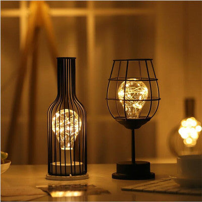 Decorative table lamps with light bulbs inside on a wooden surface.