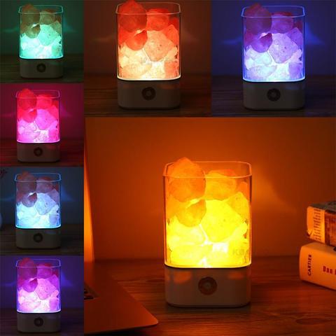 Color-changing LED lamp with rock-like design on a wooden surface.