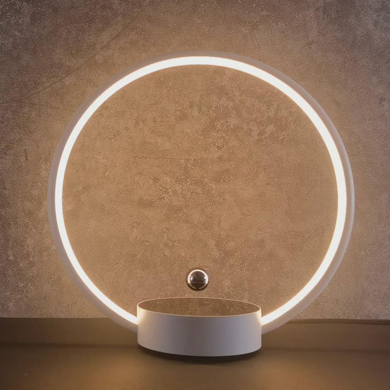 Modern wall-mounted light fixture with a circular design on a textured wall.