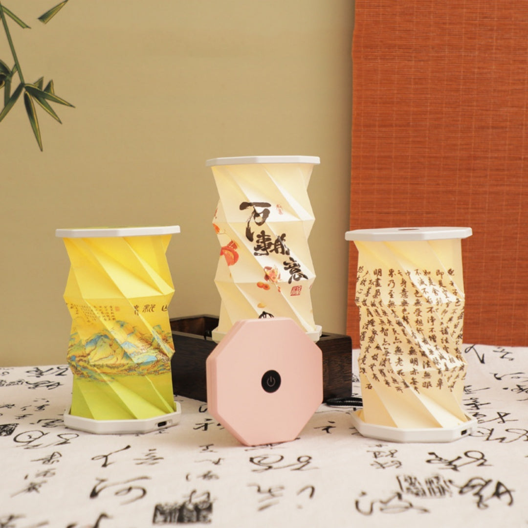 Three cylindrical packages with different designs on a table with a textured wall background