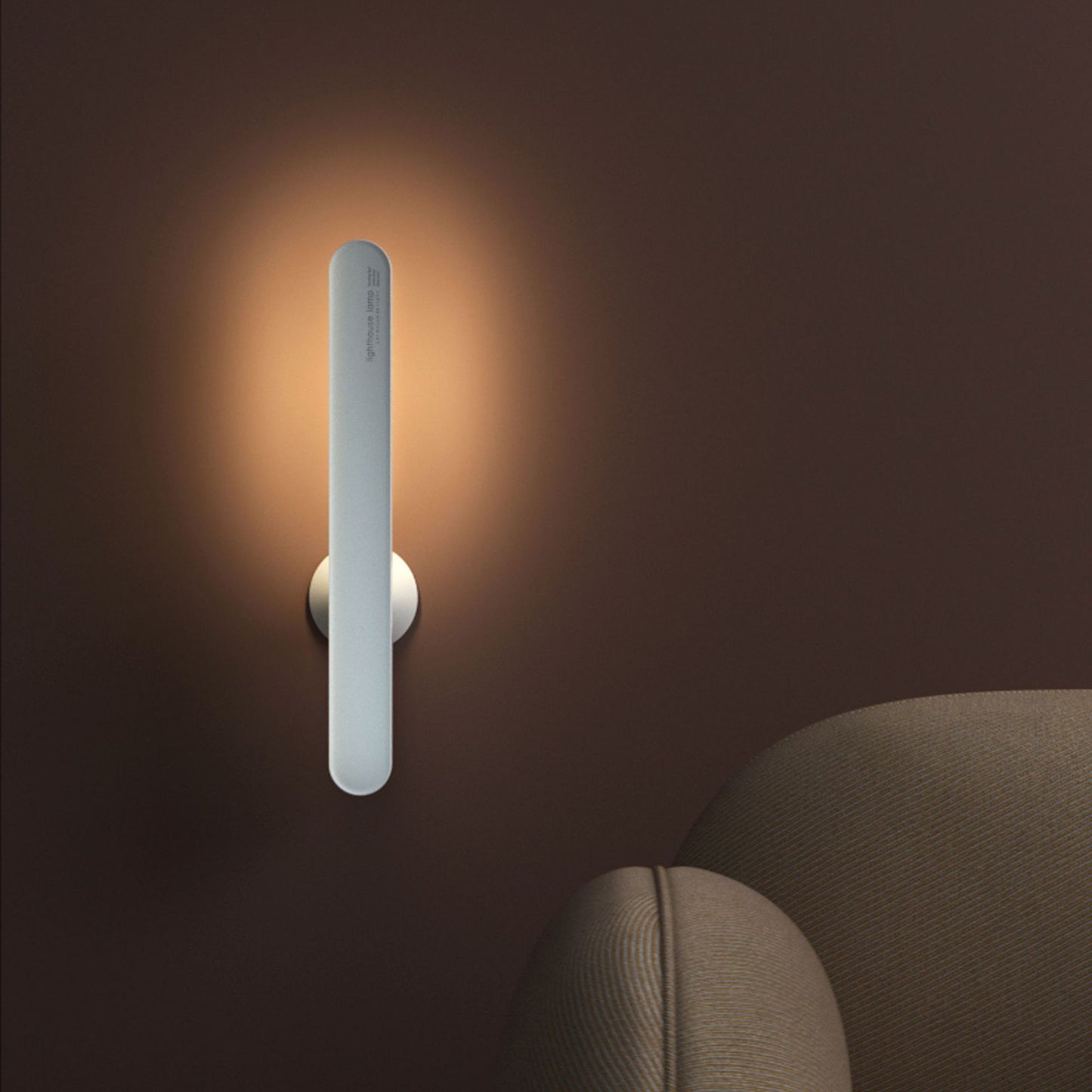Wall-mounted light fixture casting a warm glow on a dark wall.