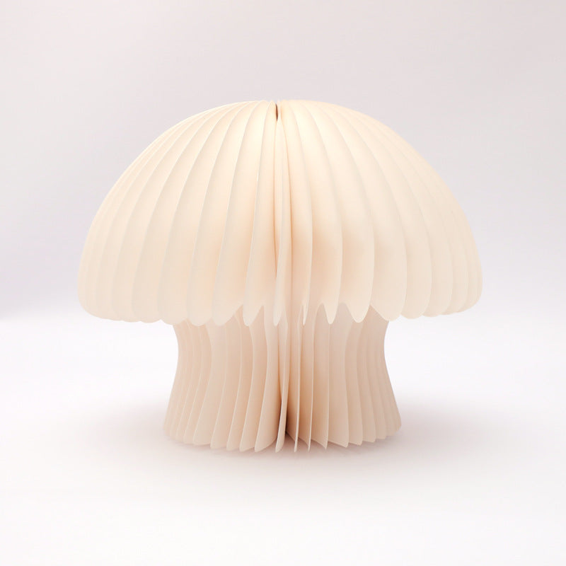 Mushroom-shaped lamp made of pleated paper on a white background