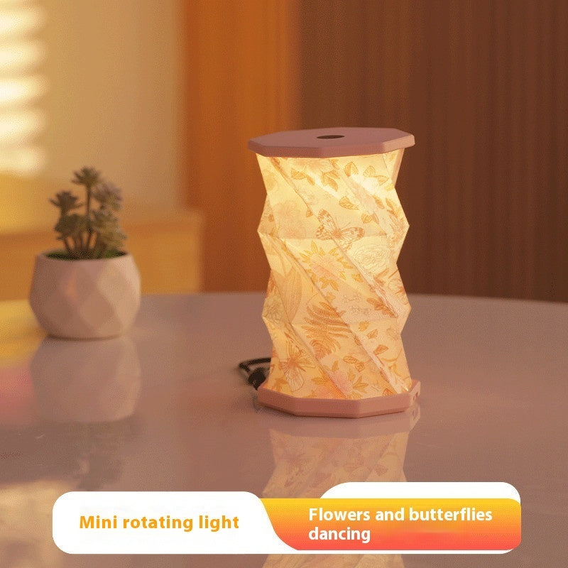 Decorative mini rotating light on a table with a blurred background