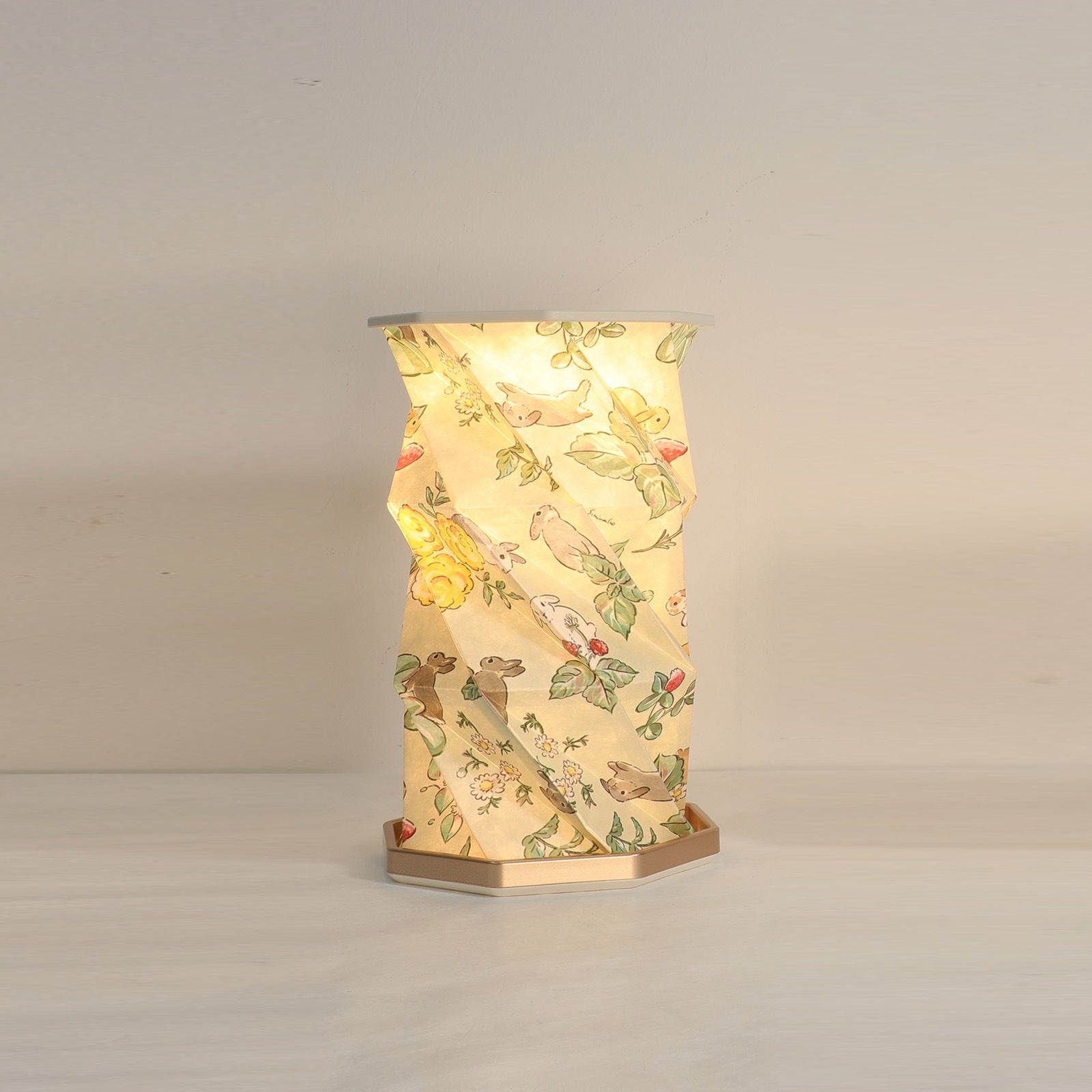 Decorative table lamp with floral pattern on a plain background