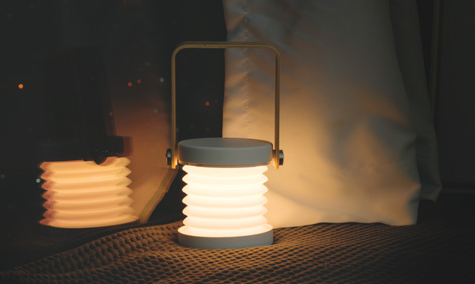 Collapsible lanterns on a dark surface with a blurred background