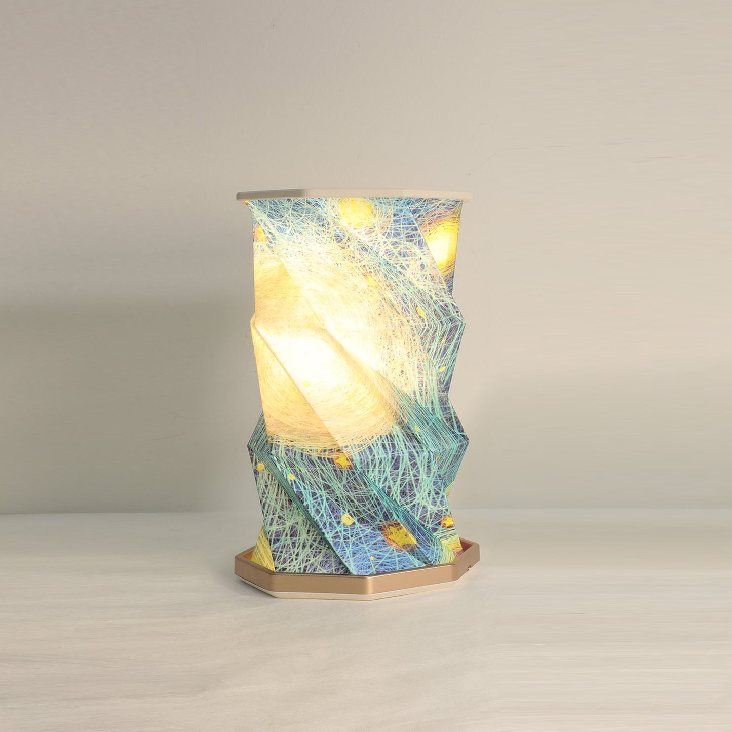 Decorative table lamp with a textured blue and yellow shade on a neutral background