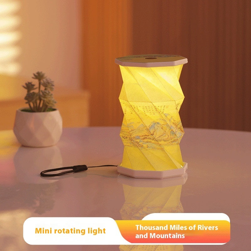 Yellow rotating light on a table with a plant in the background