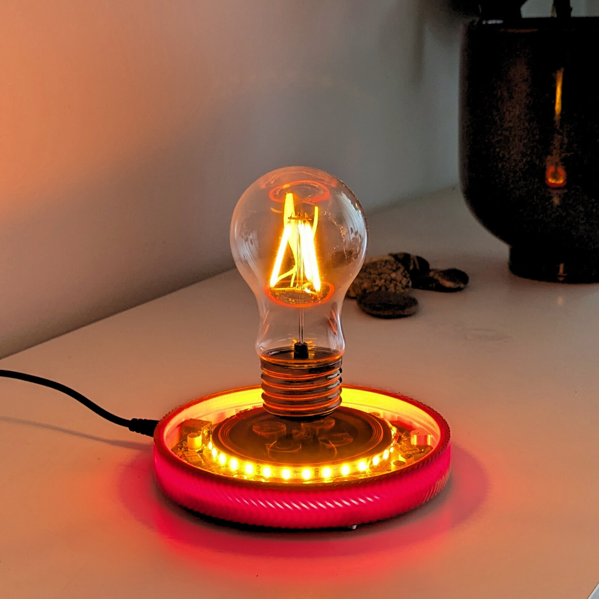 Levitating Vintage Filament Light Bulb Floating Above Glowing LED Base