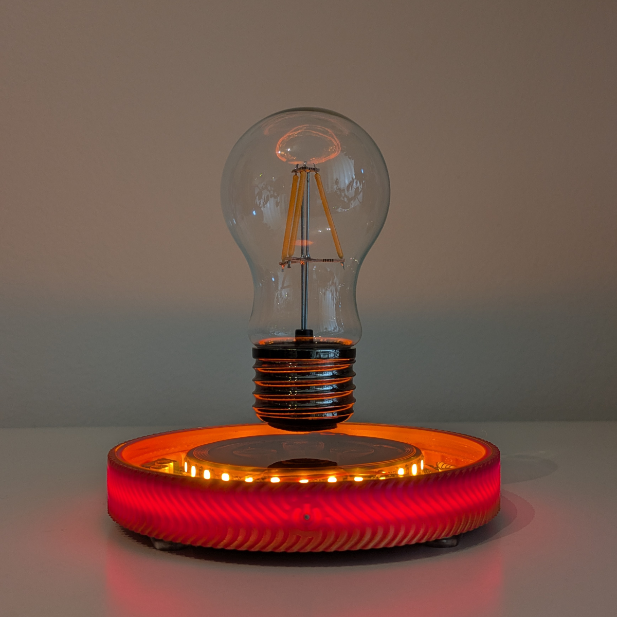 Levitating Vintage Filament Light Bulb Floating Above Glowing LED Base