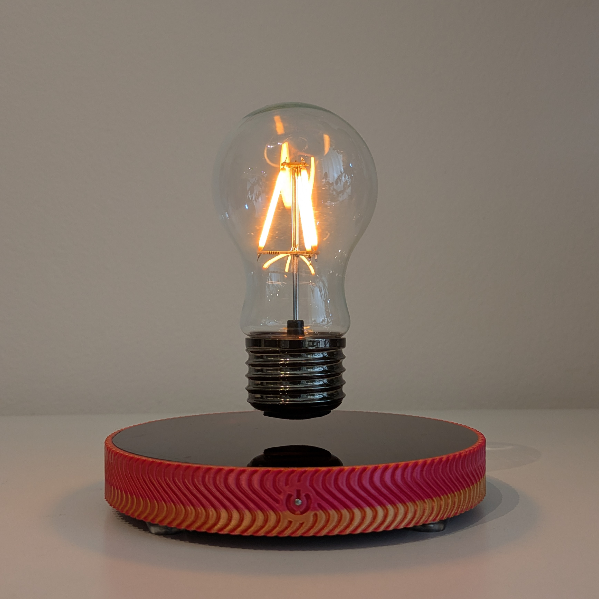 Levitating Vintage Filament Light Bulb Floating Above Glowing LED Base