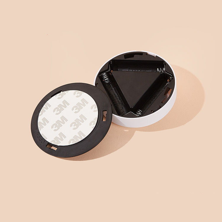 Open black and white container with '3M' label on a beige background