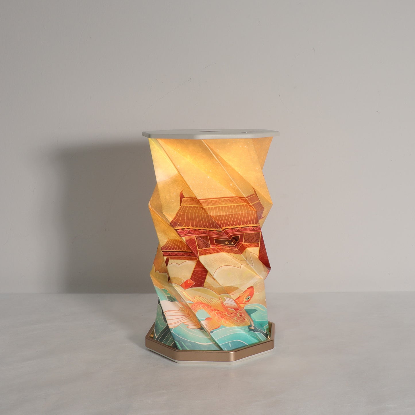 Decorative lamp with geometric design and fish illustration on a plain background