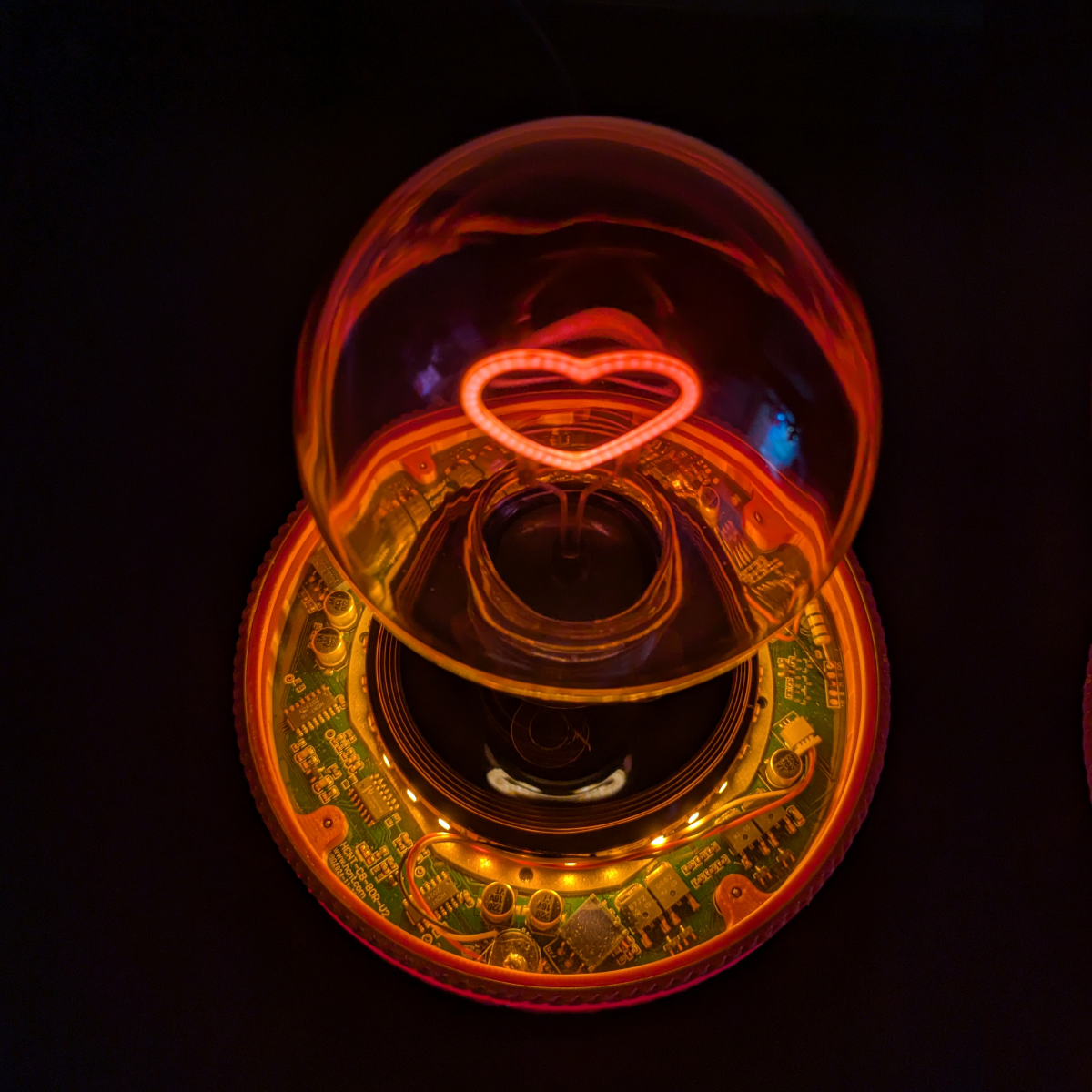 Levitating Heart Shaped Filament Light Bulb Floating Above Glowing LED Base
