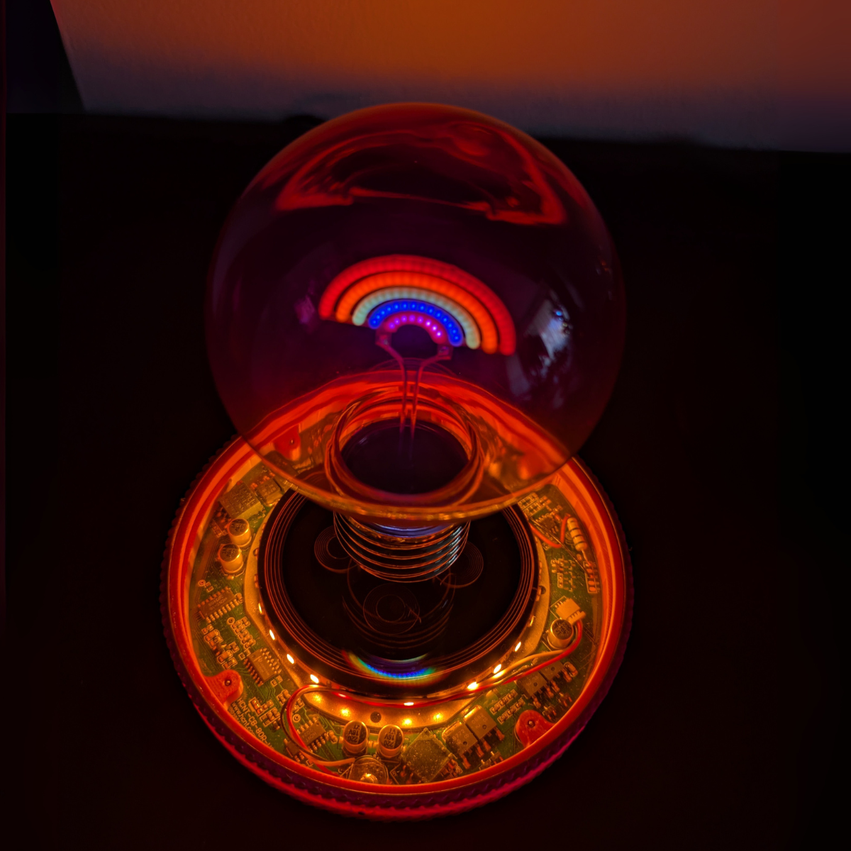 Levitating Rainbow Light Bulb Lamp Floating Above Glowing LED Base
