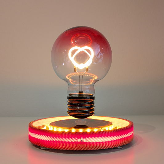 Levitating Heart Shaped Filament Light Bulb Floating Above Glowing LED Base