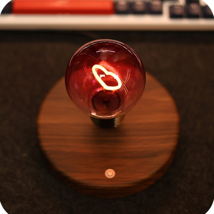 Vintage-style light bulb on a wooden base with a blurred background