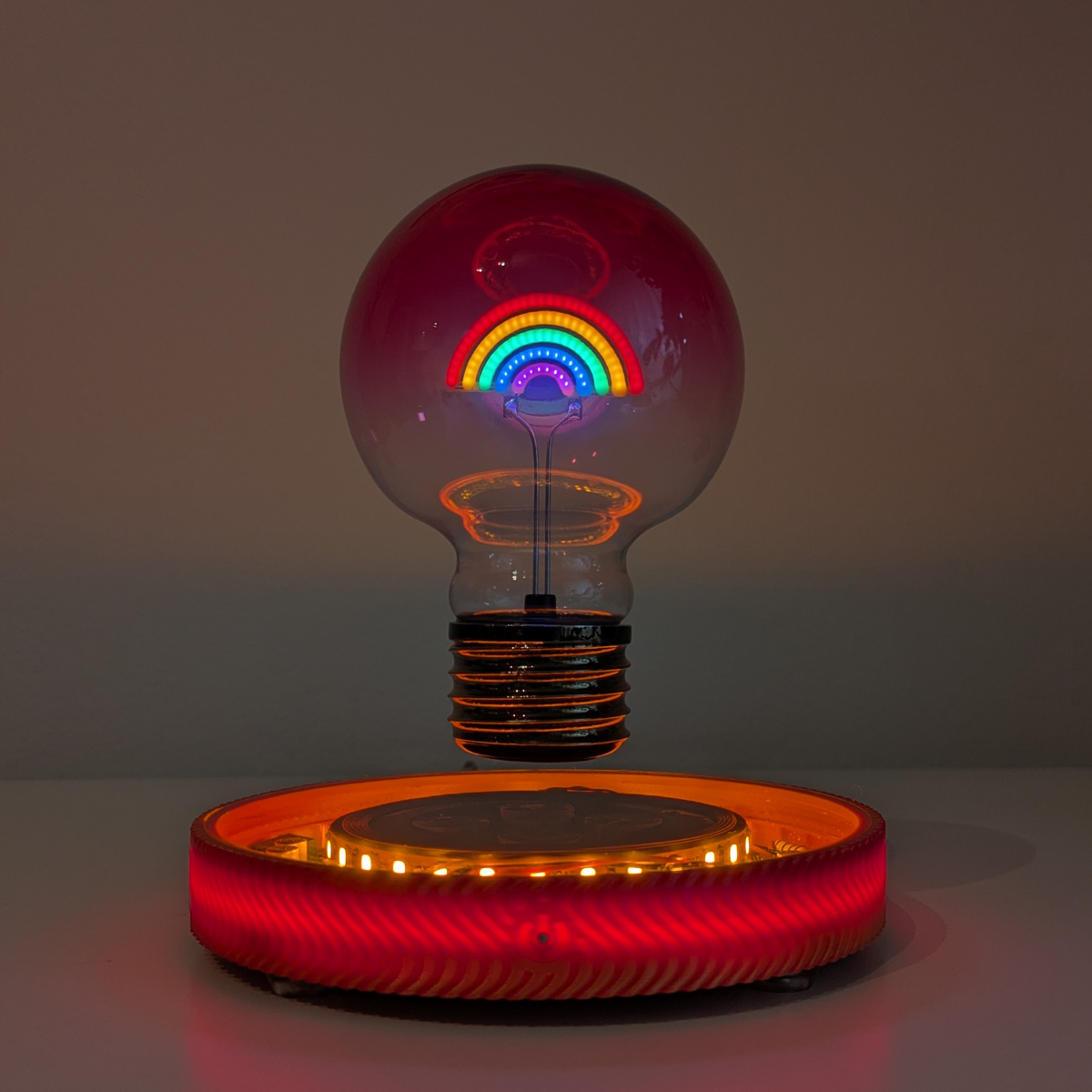 Levitating Rainbow Light Bulb Lamp Floating Above Glowing LED Base